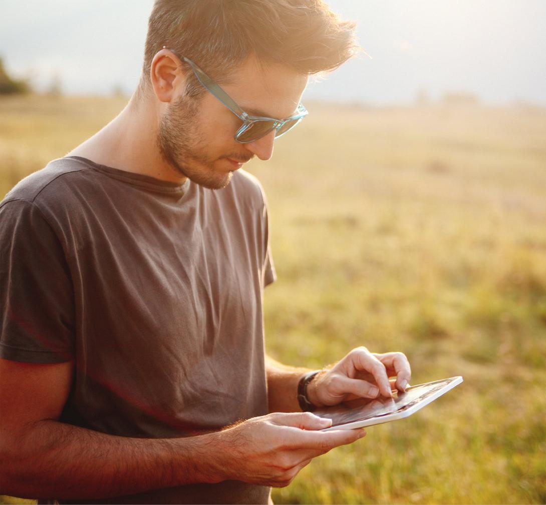 Young male checking online banking on tablet device